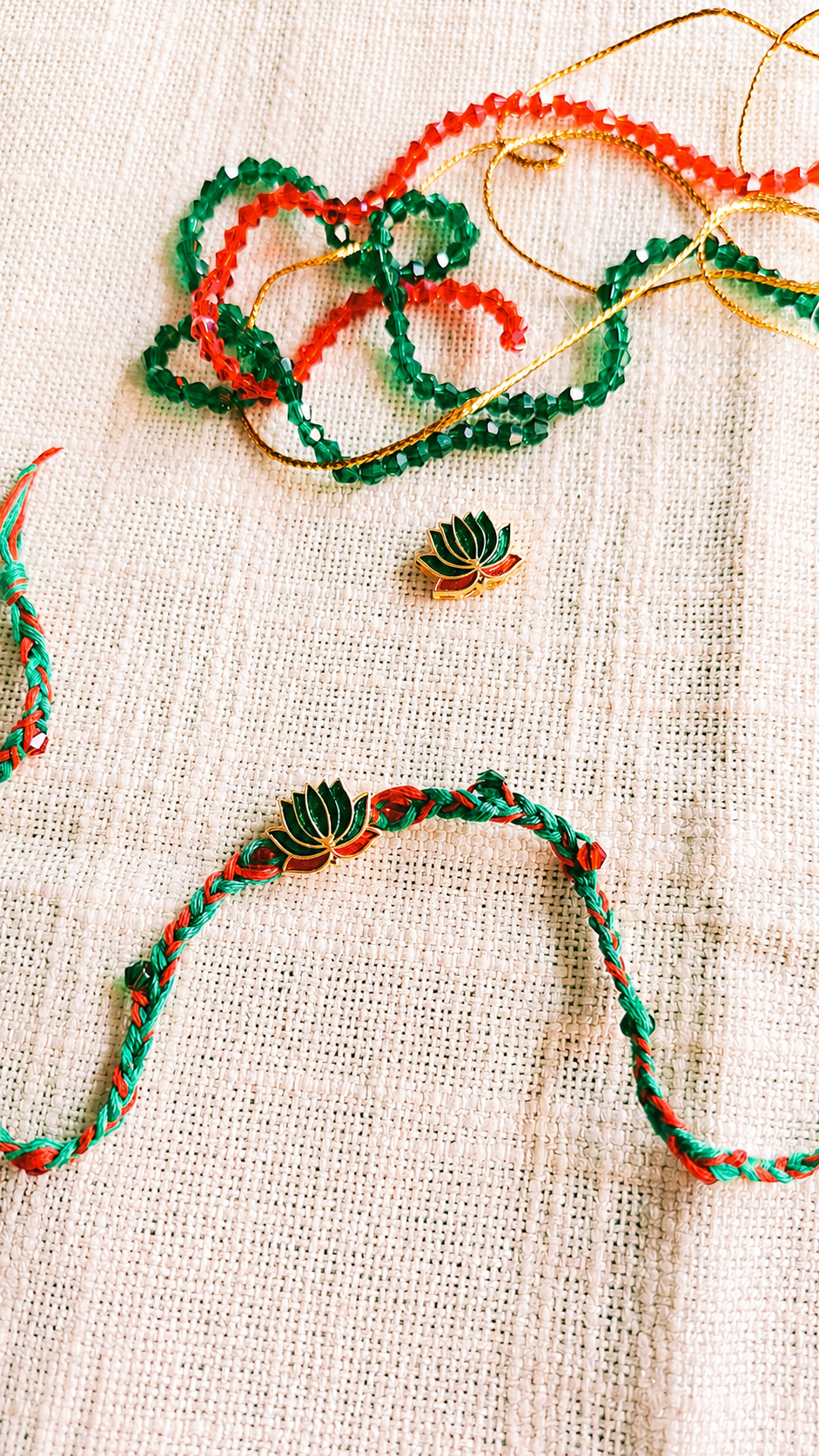 Handcrafted Meenakari Lotus Rakhi with Braided Red and Green Mauli Thread